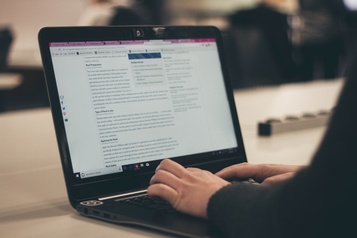 A writer editing an article on a laptop screen.